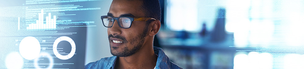 Image of a person looking at computer code on a monitor.