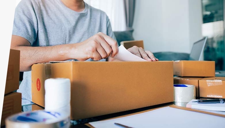 Person preparing to send a package using First-Class Package International service.