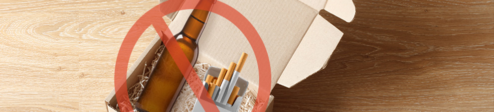 Alcohol and tobacco products in a packing box and crossed out to indicate that they cannot be shipped.