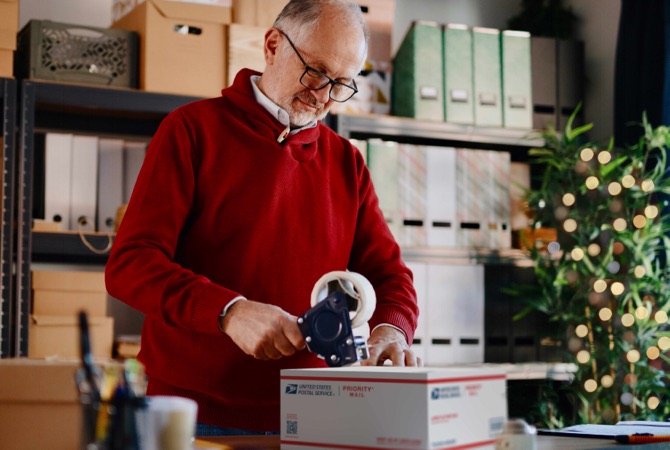 Small Business owner preparing to ship Priority Mail packages.